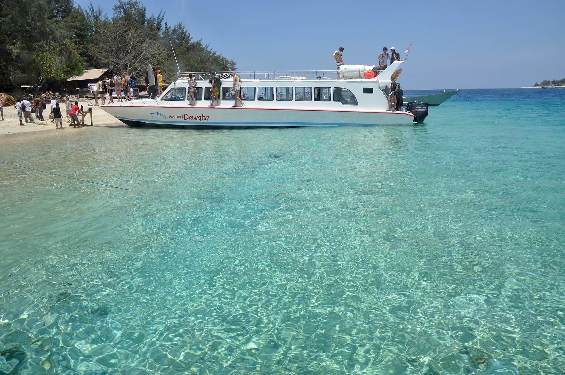 A fast boat at the beach in clear turquoise water in the Gili Islands, Lombok